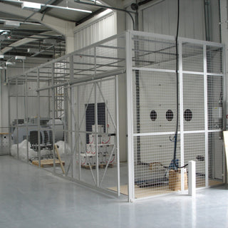 Paint finished customised mesh security cage with sliding door in a factory environment