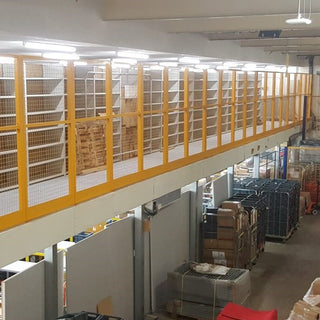 Mesh panel barrier system creates mezzanine edge protection for staff safety.